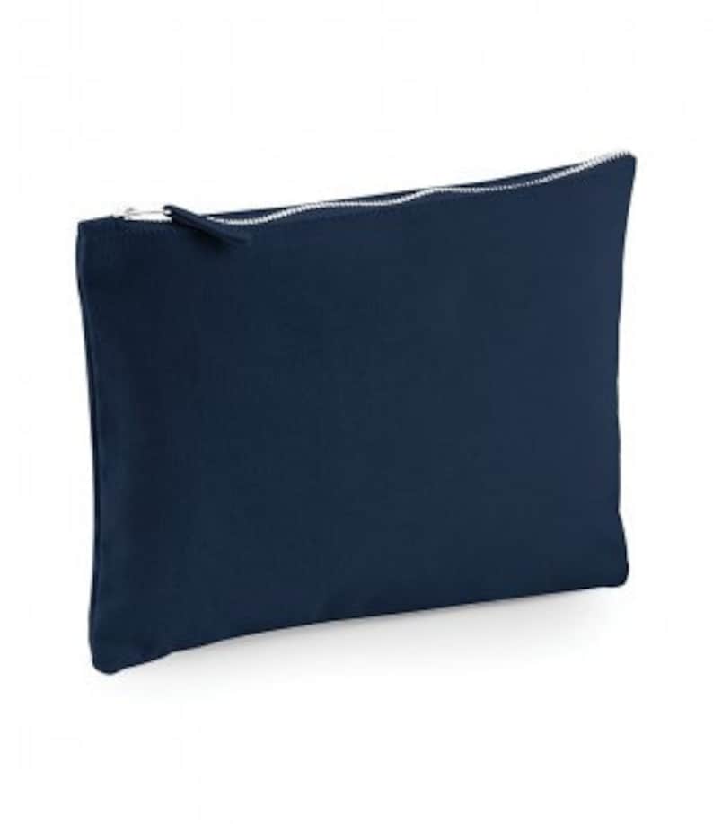 May include: A dark blue zippered pouch made of canvas.