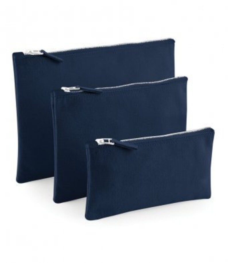 May include: Three navy blue zippered pouches of different sizes. The pouches are made of a soft, canvas-like material.