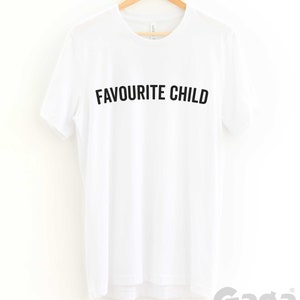 May include: White t-shirt with black text that reads "Favourite Child" on a white hanger. The text is in all caps.