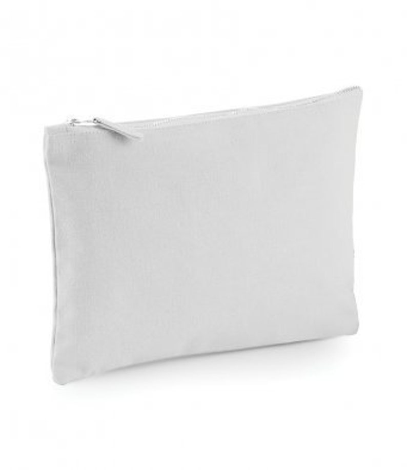 May include: A plain white canvas zippered pouch. The pouch is made of a soft, durable fabric and has a zipper closure.