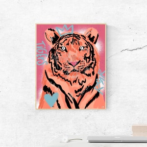 May include: A digital illustration of a pink tiger with black stripes and a crown on its head. The background is a pink and red gradient with the words "Tigers Roar" written in blue.