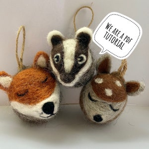 May include: Three felt animal ornaments, a fox, a badger, and a deer, with closed eyes and a white background. The text "We are a PDF tutorial" is in a speech bubble.