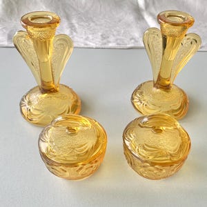 Art Deco pair of candlesticks and lidded powder bowls, amber glass dressing table set c1920s 1930s