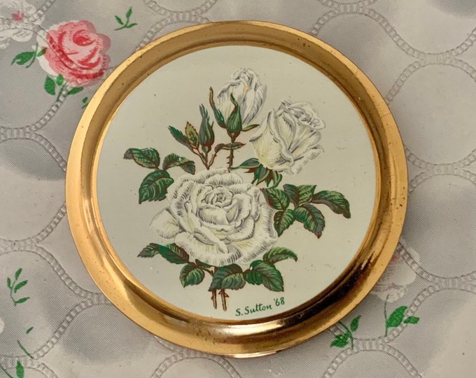 Mascot A S Brown unused powder compact with white roses, c1960s or 1970s gold tone makeup mirror