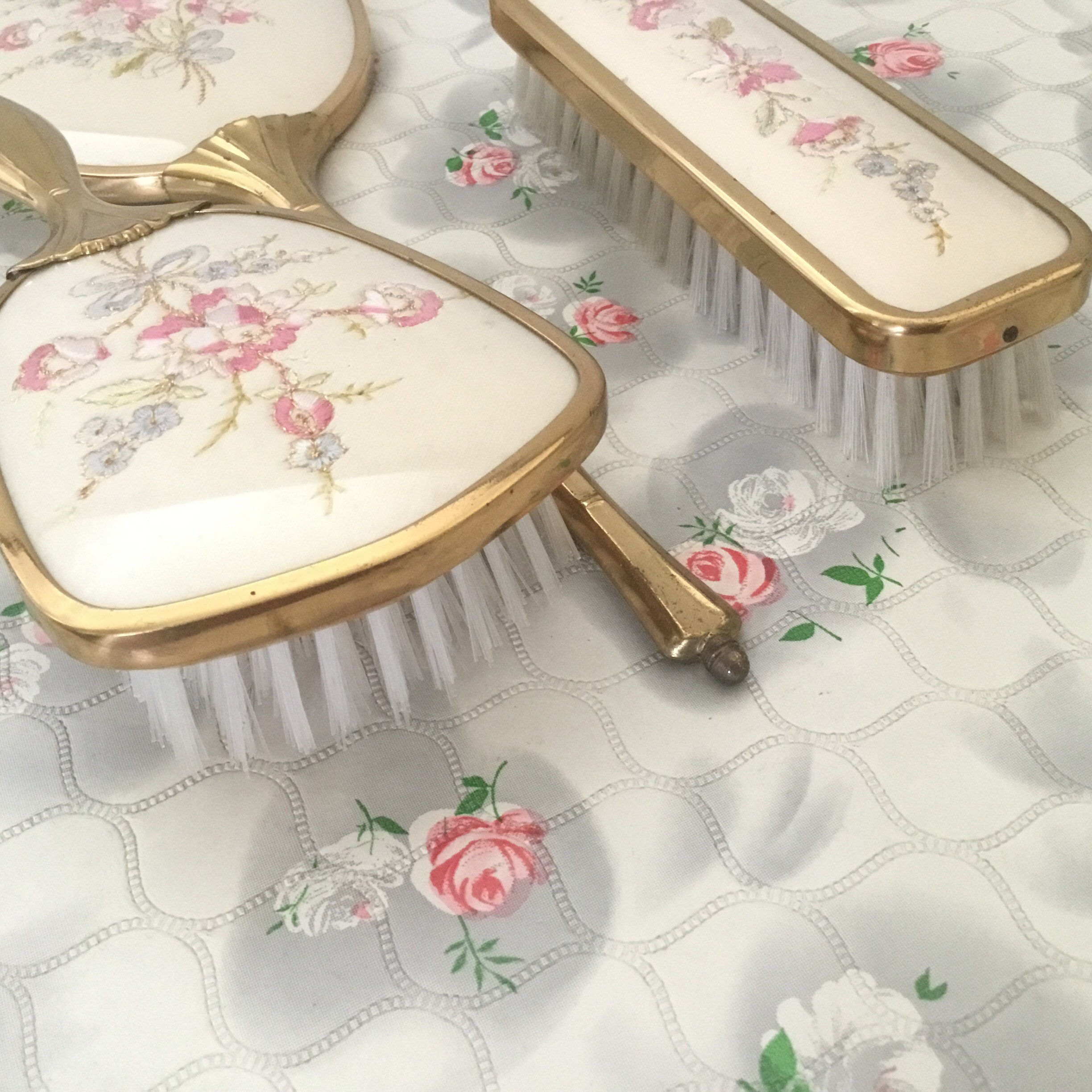 Vintage vanity set with hand mirror, hair brush, and clothes brush