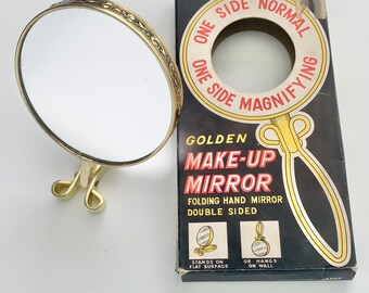 Double sided folding makeup mirror, c 1960s vintage magnifying vanity travel mirror