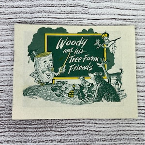 May include: A vintage illustration of a cartoon log character named "Woody" teaching a group of woodland animals. The illustration is on a green chalkboard with the text "Woody and his Tree Farm Friends".