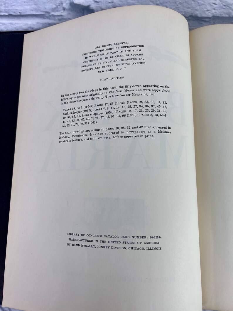 May include: A black and white book with the title "Drawings" by Charles Addams. The book includes a copyright notice and information about the first printing. The text states that the drawings in the book were originally published in The New Yorker magazine.