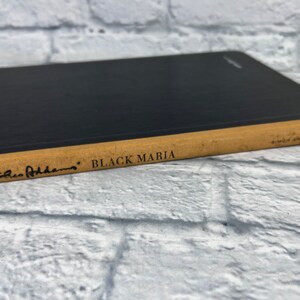 May include: A black hardcover book with a tan spine. The title "BLACK MARIA" is printed on the spine, along with the author's name "Chico  Atherton".