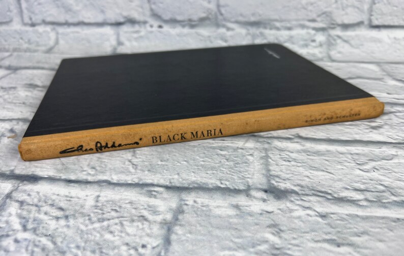 May include: A black hardcover book with a tan spine. The title "BLACK MARIA" is printed on the spine, along with the author's name "Chico  Atherton".