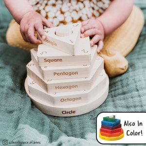 May include: A wooden stacking toy with different shapes, including a circle, octagon, hexagon, pentagon, square, and triangle. Each shape has the number of sides written on it. The toy is being played with by a baby.