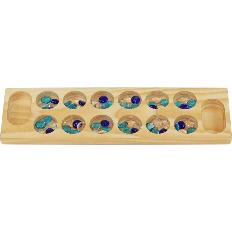 May include: A wooden game board with 14 round depressions, each containing blue and clear glass marbles. The board has two empty depressions on either end.