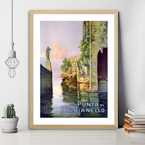 May include: Vintage travel poster featuring a scenic view of Punta di Balbianello, a picturesque location in Italy. The poster depicts a stone building with a lush garden and a calm body of water in the foreground. The text "Punta di Balbianello" is prominently displayed at the bottom of the poster.