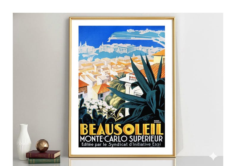 May include: Framed vintage travel poster for Beausoleil, Monte-Carlo Sup&eacute;rieur, featuring a cityscape with red-tiled roofs, blue sky, and dark green plant life. The poster has gold lettering and a gold frame.