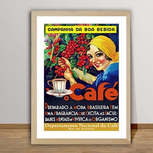 May include: A framed vintage coffee advertisement in Portuguese. It features a woman in a yellow headscarf with coffee cherries, a cup of coffee, and the word "Caf&eacute;". The poster has text in Portuguese and is framed in a light wood frame.