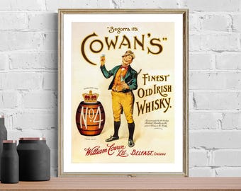 May include: A framed vintage advertisement for Cowan's Finest Old Irish Whisky. The poster features a smiling man holding a glass, a barrel with "No. 4" on it, and text that reads "Begorra it's Cowan's" and "William Cowan Ltd, Belfast, Ireland."