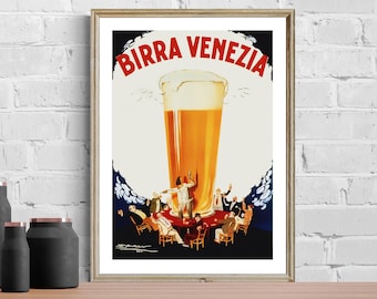 May include: Framed vintage poster advertising "Birra Venezia" beer. The poster features a large glass of beer with a foamy head, and a group of people gathered around a table. The poster is in a gold frame and is displayed on a wooden surface.