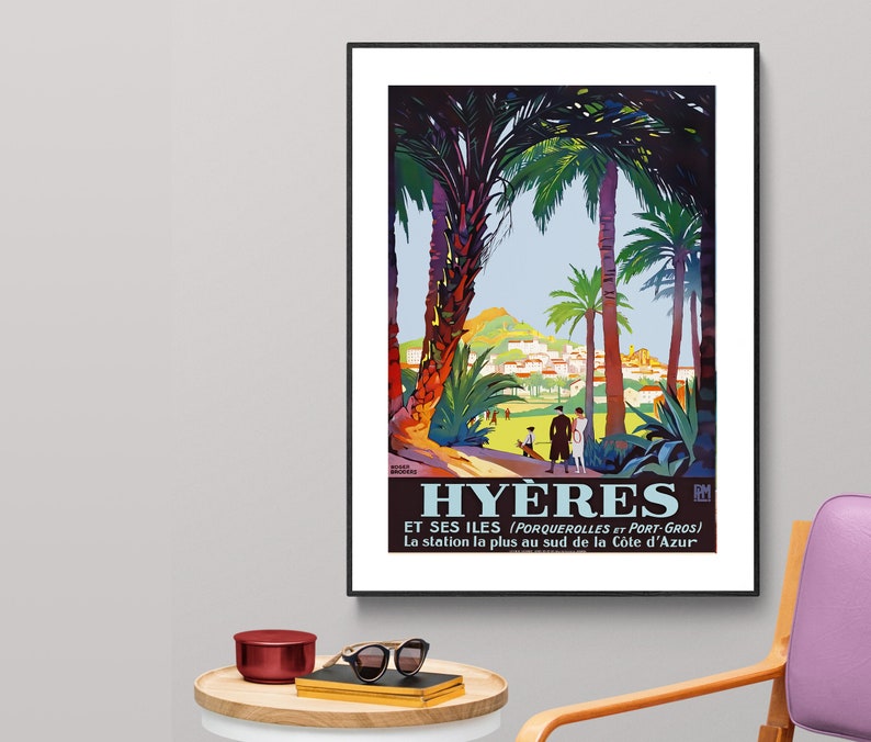 May include: A vintage travel poster advertising Hy&egrave;res, a town in the south of France, with the text "Hy&egrave;res et ses &icirc;les (Porquerolles et Port-Gros) La station la plus au sud de la C&ocirc;te d'Azur". The poster features a colourful illustration of palm trees, a hillside town, and people walking along a path.
