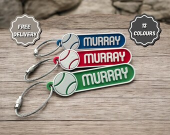 May include: Three personalized keychains with a baseball design. The keychains are blue, red, and green with the name "MURRAY" printed in white on each keychain.