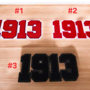 May include: Three versions of the number 1913, each with a different style. The first two are red with white outlines, and the third is black. The numbers are labeled #1, #2, and #3.