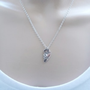 May include: A silver necklace with a heart-shaped pendant that says "Friends in Time".
