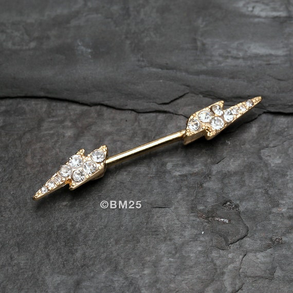 A Pair of Golden Sparkle Lightning Bolt Nipple Barbell Ring clear