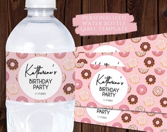 May include: Printable water bottle label template featuring a pink background with a donut pattern. The label has a circle in the center with the text "Katherine's Birthday Party 11.17.2023".