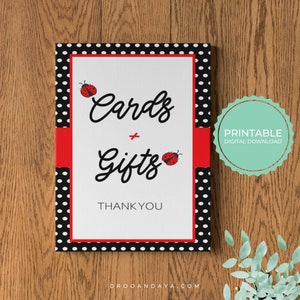 May include: Printable sign with black and white polka dots and a red ribbon. The sign says "Cards & Gifts" with a ladybug illustration on each side. The text "Thank You" is below the main text. The sign is labeled "Printable Digital Download".