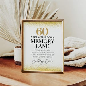 Puede incluir: Un cartel blanco con detalles de purpurina dorada y texto negro. El cartel dice "60 Take a Trip Down Memory Lane Please Write Your Favorite Memory, A Funny Story, Birthday Wishes or Words of Love for the Birthday Queen".