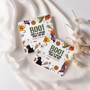 May include: Two Halloween-themed cards with the word "BOO!" and the message "Here's a special treat for you. Happy Halloween!" surrounded by illustrations of pumpkins, ghosts, and black cats. The cards are on a white background.