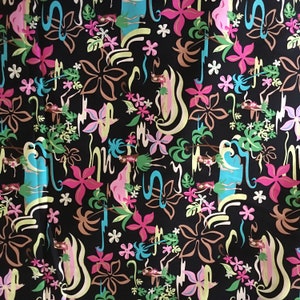 May include: A black fabric with a repeating pattern of colorful flowers, leaves, and abstract shapes. The pattern is reminiscent of a tropical island theme.