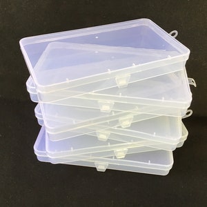 May include: A stack of six clear plastic storage boxes with lids. The boxes are rectangular and have a smooth, glossy finish.