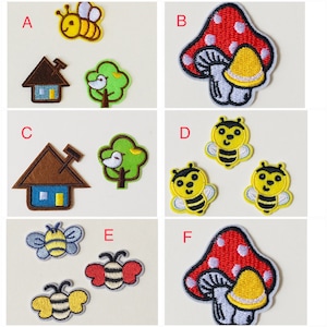 May include: Six embroidered iron-on patches featuring a bee, a house, a tree, a mushroom, and a bee. The patches are in various colors, including yellow, brown, green, red, and white.
