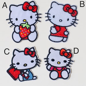May include: Four embroidered iron-on patches featuring Hello Kitty in different poses. The patches are white with black outlines and feature red, pink, and blue details. The patches are labelled A, B, C, and D.