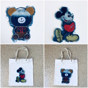 May include: Two tote bags with denim patches. One bag features a blue denim Mickey Mouse patch and the other bag features a blue denim bear patch.
