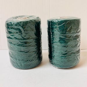 May include: Two spools of dark green twine wrapped in clear plastic.