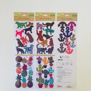 May include: Three sheets of iron-on transfers featuring various designs. The first sheet has 12 dog and cat silhouettes with different patterned designs. The second sheet has 12 cactus and pineapple silhouettes with different patterned designs. The third sheet has 12 anchor silhouettes with different patterned designs. The package includes instructions for using the iron-on transfers.