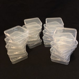 May include: A stack of clear plastic storage boxes with lids. The boxes are stacked in two piles, each with six boxes.