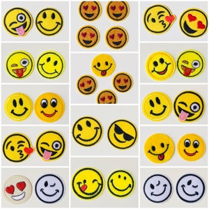 May include: A collection of 20 yellow embroidered iron-on patches featuring various smiley faces with different expressions, including winking, tongue sticking out, sunglasses, hearts, and a single eye.