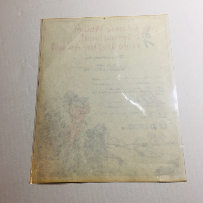 May include: A vintage print of a golfer in a red jacket and white pants, with a golf club in hand, standing on a green field. The print is titled "The Golfing One" and has the text "The original copyright" at the bottom.