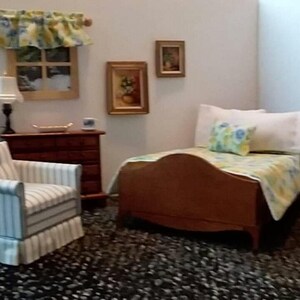 May include: A bedroom with a wooden bed, a striped armchair, a wooden dresser, and a wooden armoire. The bed has a white and yellow floral bedspread and two pillows. The armchair is light blue and white striped. The dresser has three drawers. The armoire has two doors.