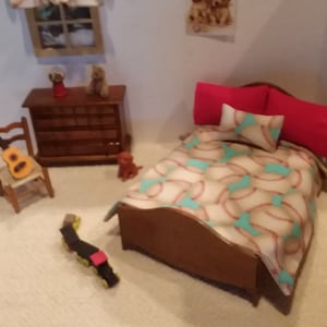May include: A dollhouse bedroom with a wooden bed, a baseball-themed quilt, red pillows, and a wooden dresser. There is a guitar and a toy train on the floor.