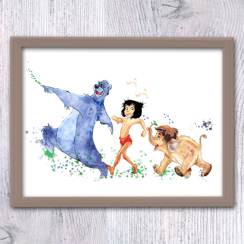 May include: Watercolour painting of Baloo the bear, Mowgli, and Bagheera the panther from Disney's The Jungle Book. The characters are depicted in a playful, dancing pose with splashes of green, blue, and orange paint in the background.