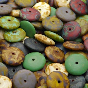 May include: A collection of colourful, round, flat glass beads with a hole in the centre. The beads have a variety of patterns and colours, including brown, green, blue, red, and white.