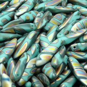 May include: A pile of teal iridescent glass beads with a pointed oval shape. The beads have a marbled pattern with shades of gold, green, and blue.