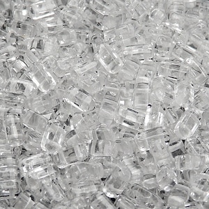 May include: A close-up view of a pile of clear, translucent, sugar crystals.