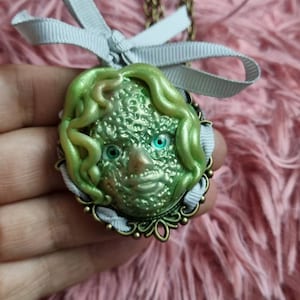 Creepy doll head pendant, ooak  hand sculpted art doll head pendant