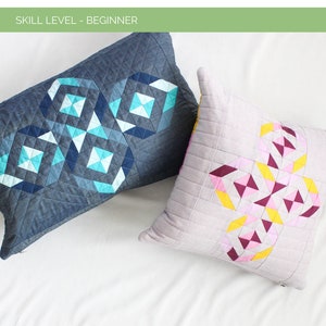 May include: Two quilted pillow covers with geometric patterns. The pillow on the left is blue denim with a teal and white diamond pattern. The pillow on the right is light gray with a pink, yellow, and burgundy diamond pattern. The text "Etched Diamond Modern Pillow Pattern" is at the top of the image. The text "Skill Level - Beginner" is below the title. The text "Sizes - Square 18" x 18" & Lumbar 23" x 15" is at the bottom of the image. The text "Shannon Fraser Designs" is at the bottom of the image.