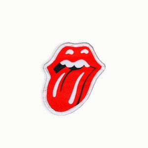 May include: A red and white tongue and lips patch with a black outline. The tongue is sticking out and has a white stripe down the middle.