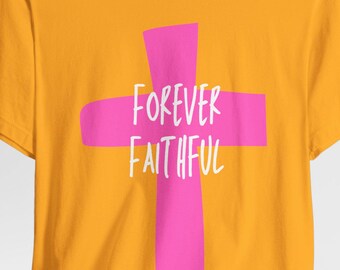 May include: Mustard yellow t-shirt featuring a large pink cross with the words "FOREVER FAITHFUL" in white script. The short-sleeved shirt is made of a soft material and is suitable for casual wear.